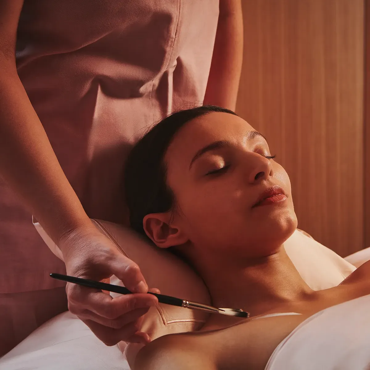 A red sofa with simple, modern upholstery and straight armrests.
