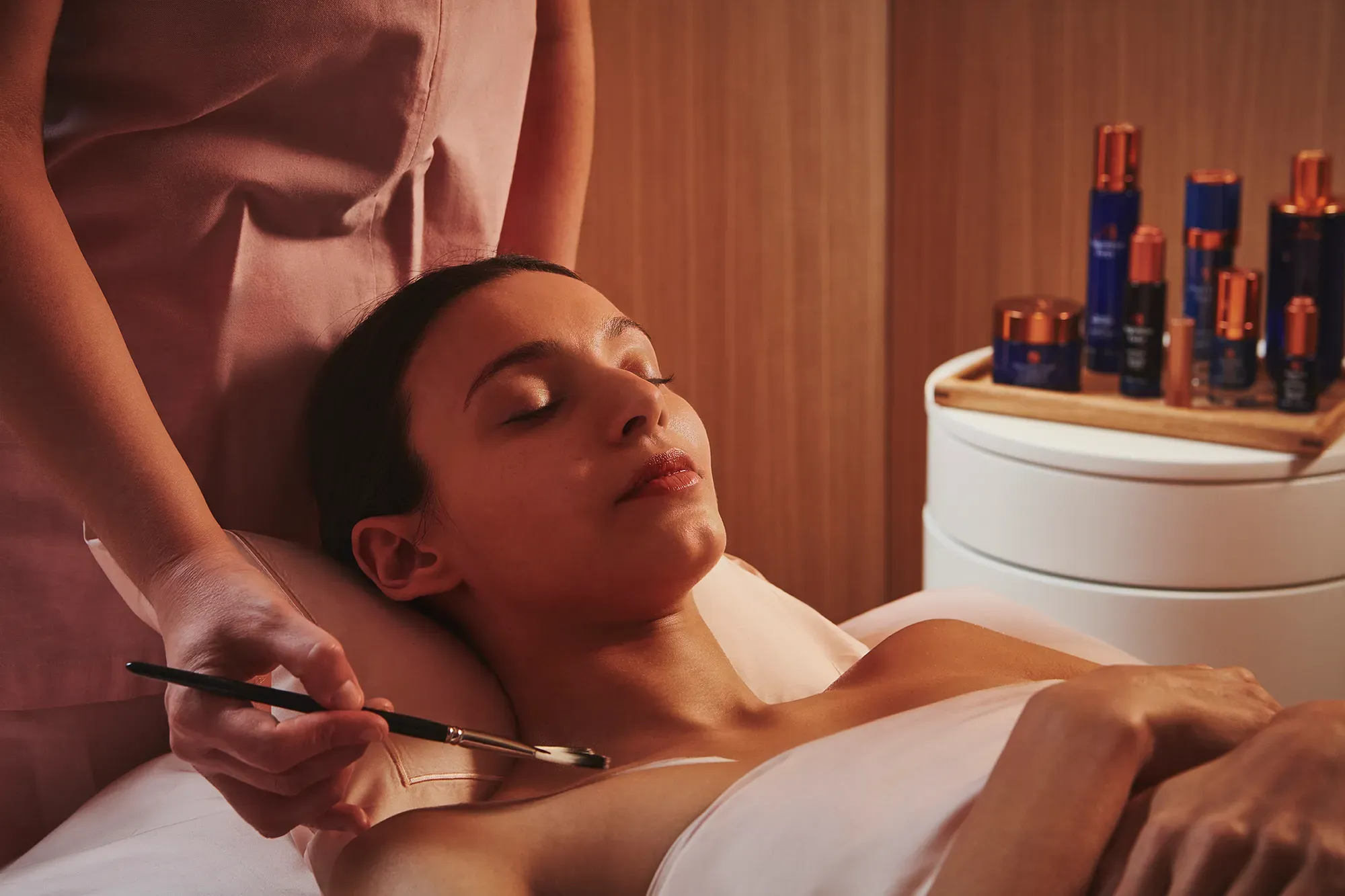 A red sofa with simple, modern upholstery and straight armrests.