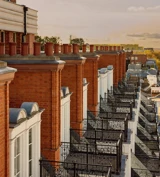 Row of red-brick façades with ornate black balconies at Claridge’s, overlooking Mayfair at sunset