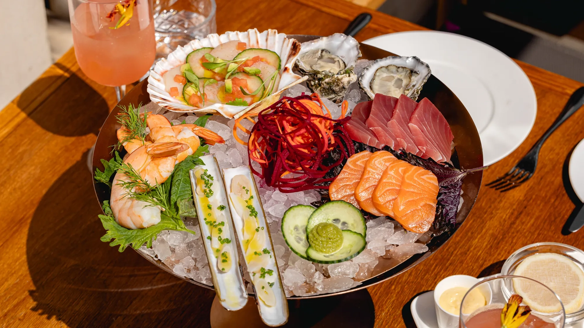 	Plate of sashimi featuring sliced raw fish arranged in rows with garnish on the side.