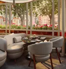 Bright dining alcove with curved white seating, round table, and large windows overlooking trees and flower boxes.