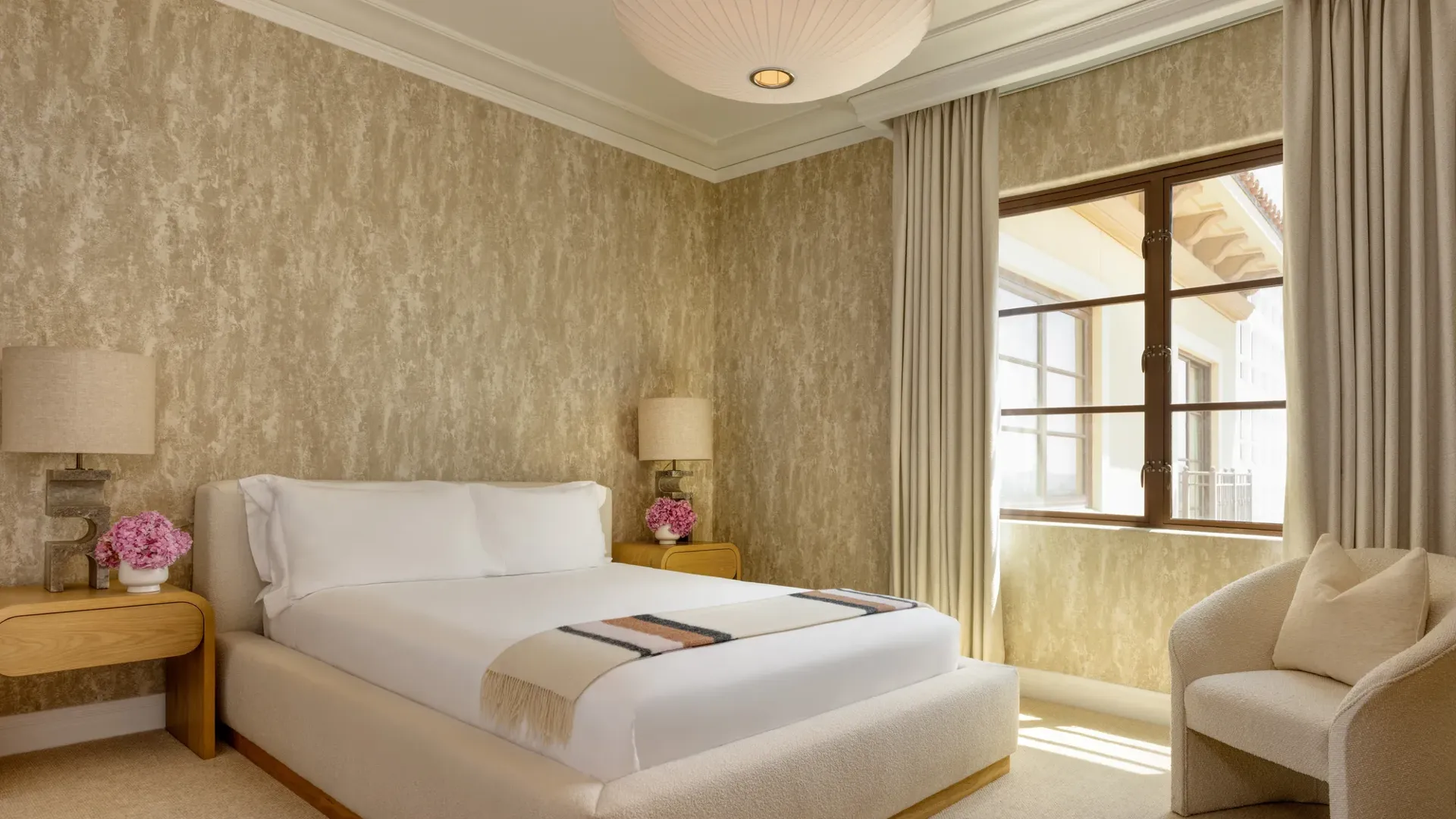 Bathroom in the Wilshere Three-Bedroom Residence, featuring a freestanding bathtub, double vanity, and marble finishes.