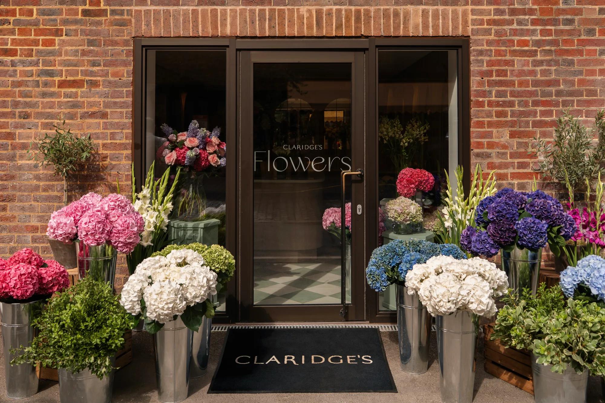 Entrance to Claridge’s Flowers, framed by vibrant seasonal blooms and elegant floral displays.