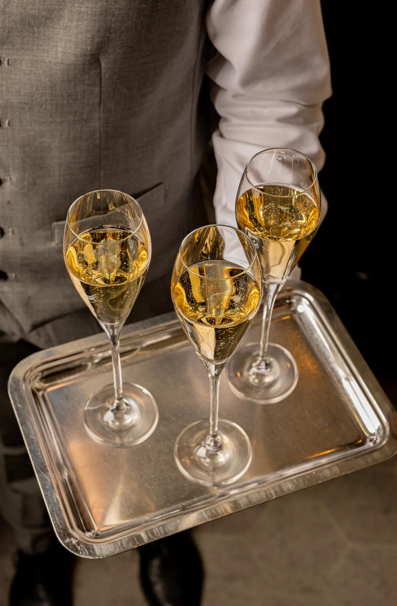 Close-up of three glasses of champagne with bubbles rising to the surface.