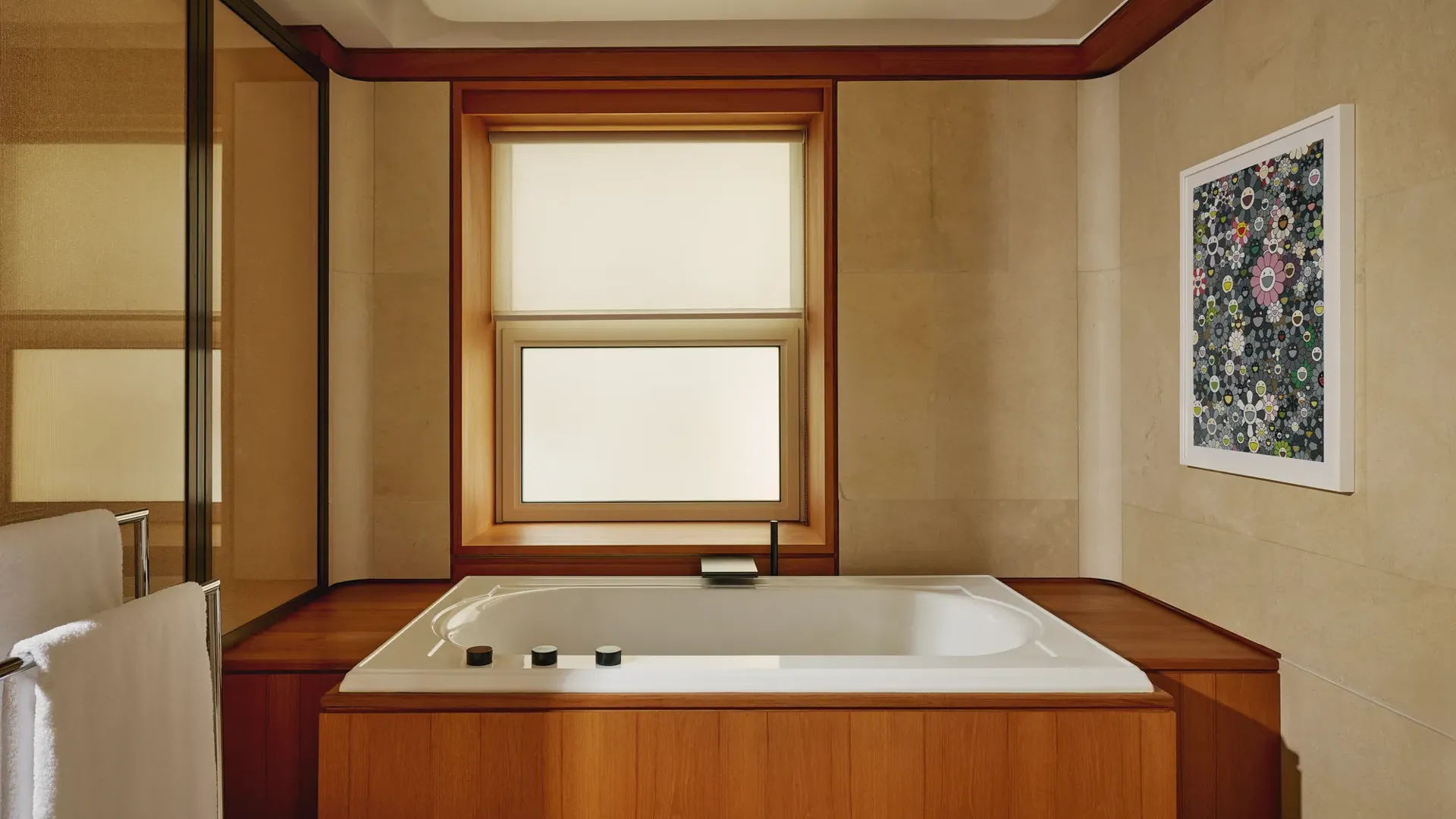 Bathroom with a built-in soaking tub surrounded by warm wood paneling, beige walls, and contemporary floral artwork.