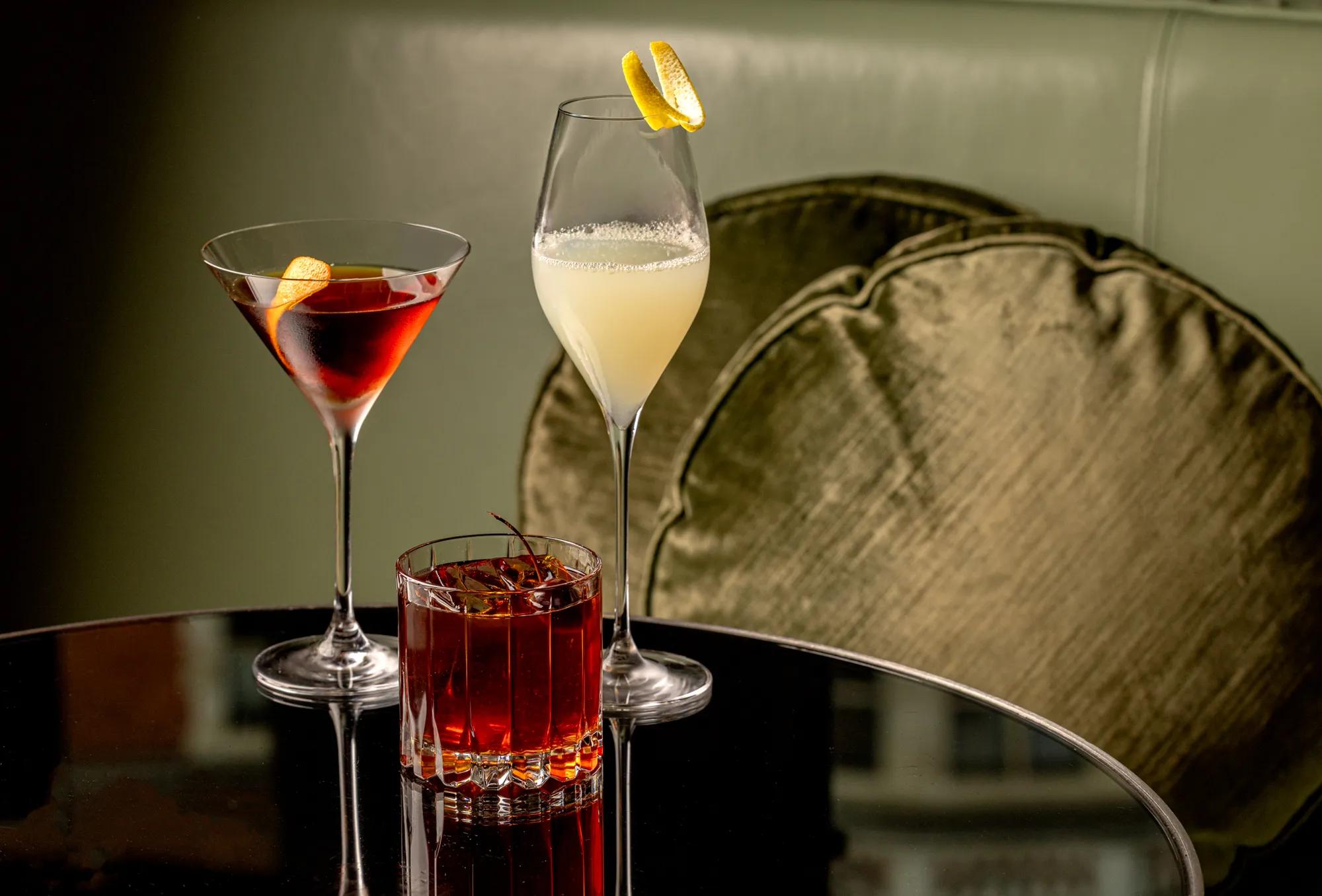 A photo of three cocktails on a table