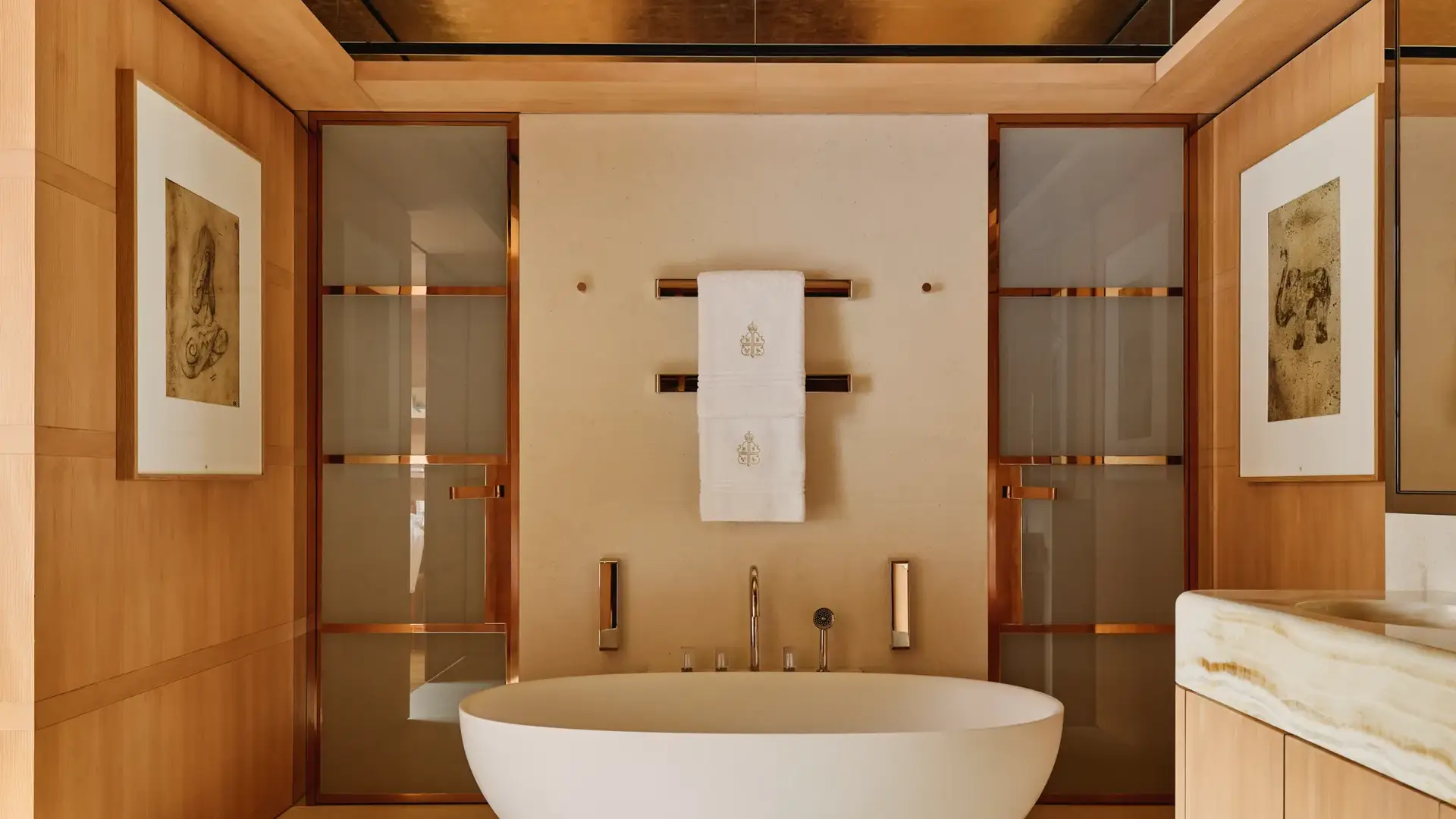 Elegant bathroom at Claridge’s with a freestanding oval bathtub, warm wood panelling, and soft lighting.