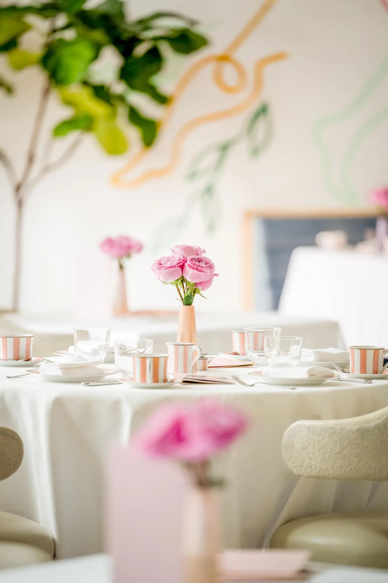 Table set for afternoon tea with pink roses and striped china at The Terrace.