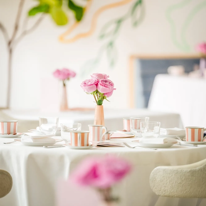 Table set for afternoon tea with pink roses and striped china at The Terrace.