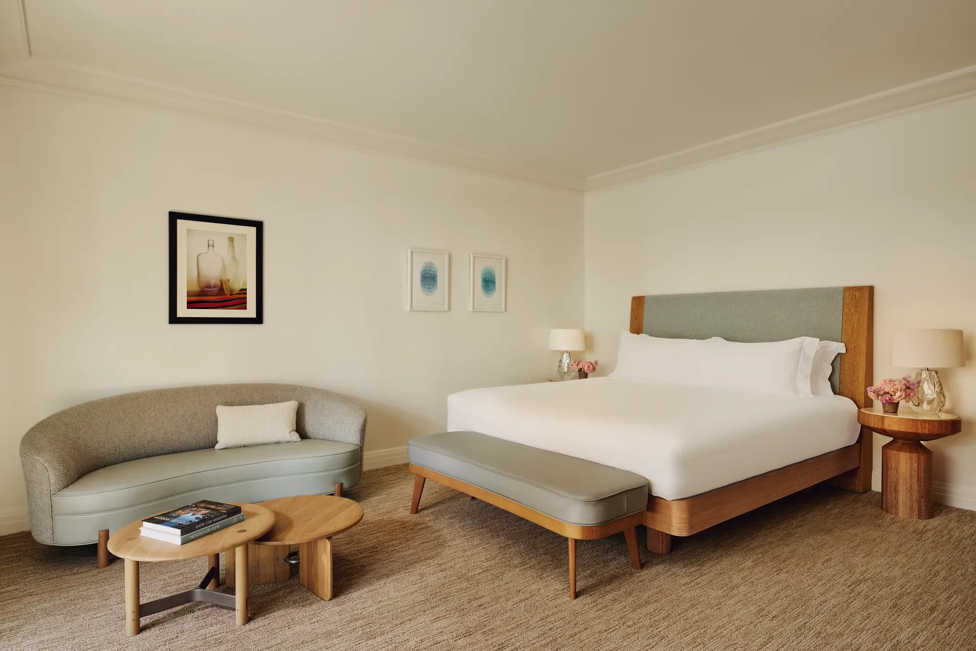 Deluxe Room with king bed, upholstered headboard, and warm-toned décor.