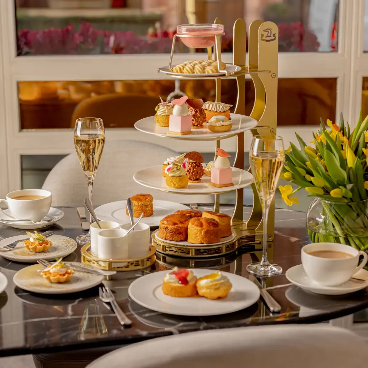 A Mother’s Day afternoon tea selection at Jean‑Georges, featuring elegantly presented pastries, sandwiches, and seasonal treats arranged with refined, celebratory detail.