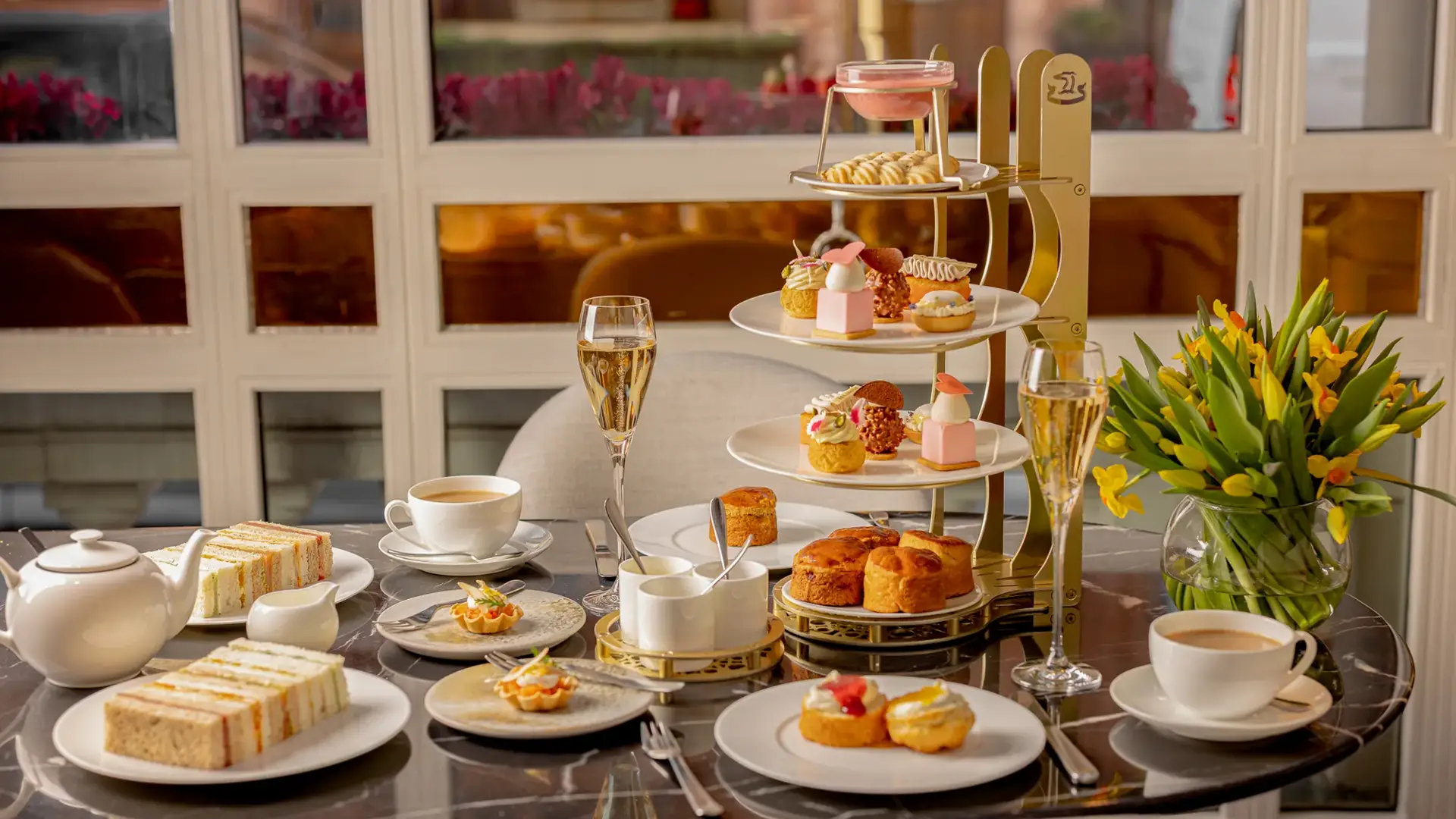 A Mother’s Day afternoon tea selection at Jean‑Georges, featuring elegantly presented pastries, sandwiches, and seasonal treats arranged with refined, celebratory detail.