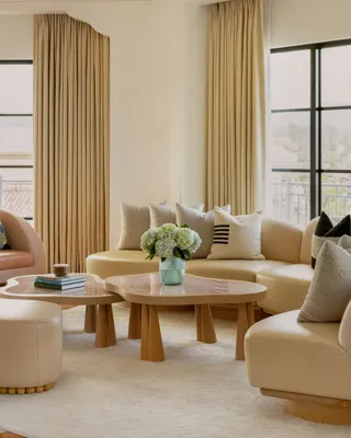 Hollywood Suite lounge corner with curved sofa and panoramic Beverly Hills outlook.