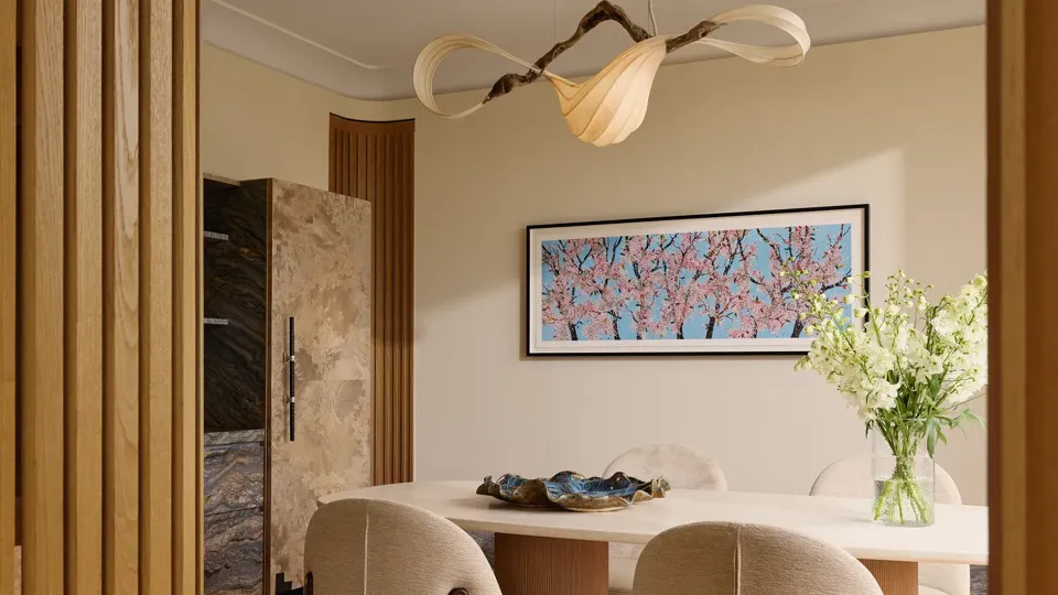 Elegant dining space with a white marble table, upholstered chairs, and a sculptural chandelier above.