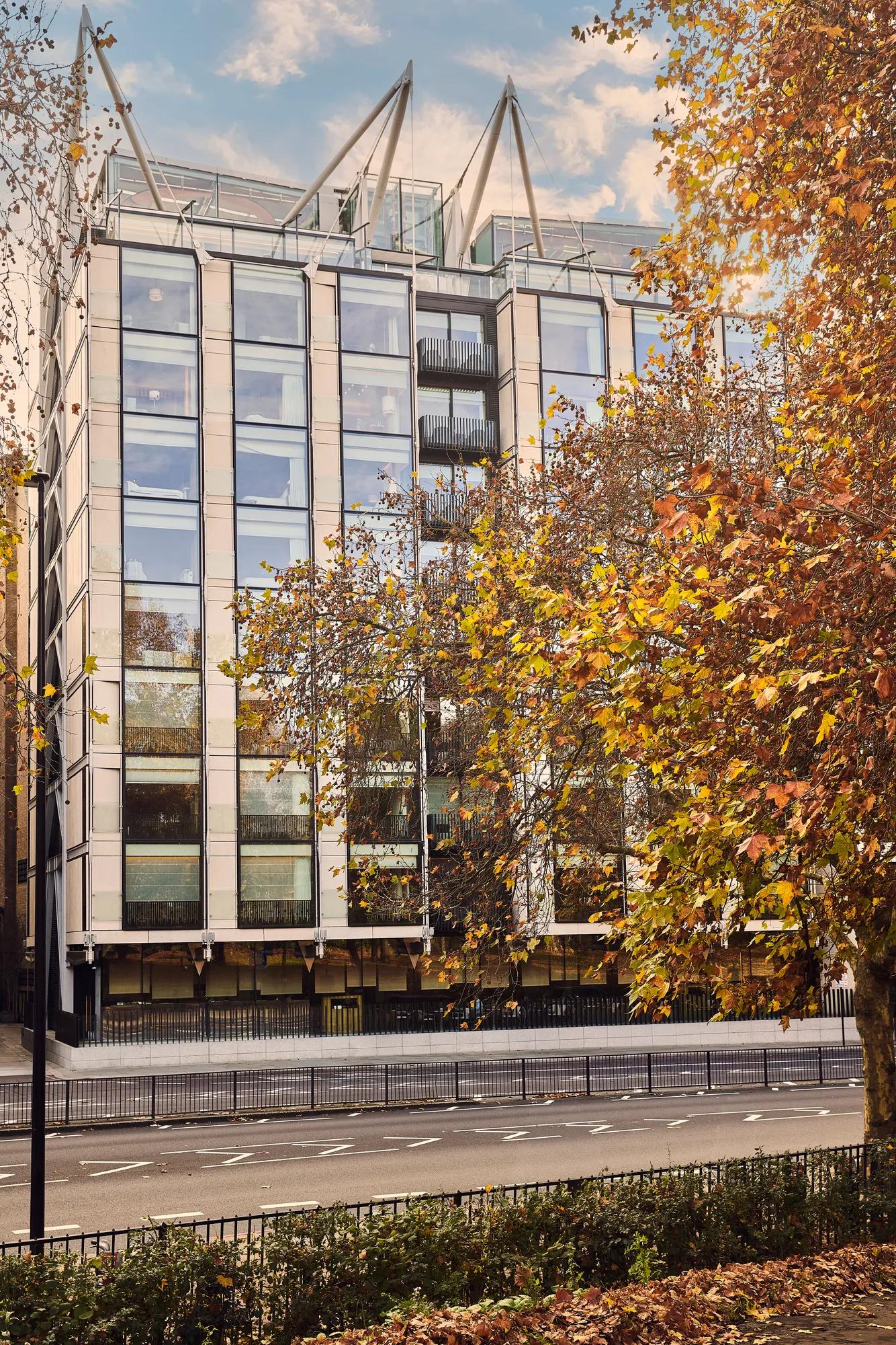 An exterior image of the hotel with autumnal leaves