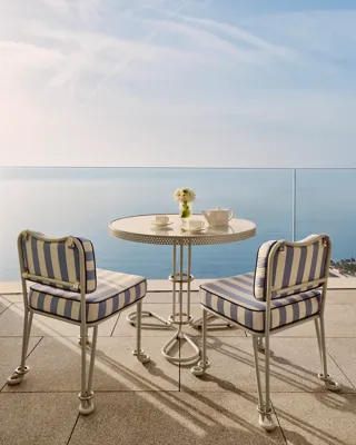 A Grand Sea View Studio at Maybourne Riviera, featuring elegant contemporary décor and expansive windows framing sweeping views of the Mediterranean coastline.