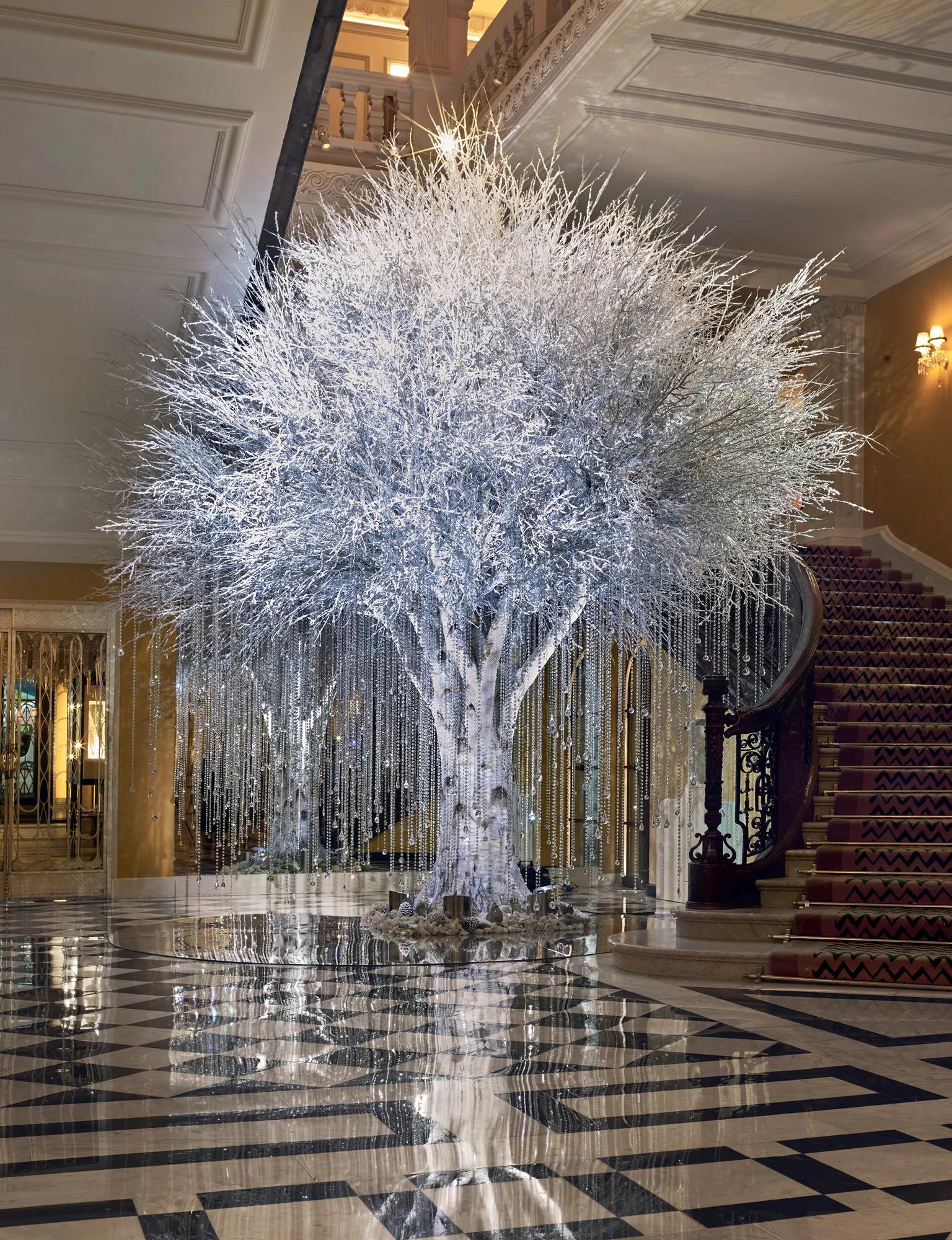 A sparkling white winter tree displayed in Claridge's lobby.