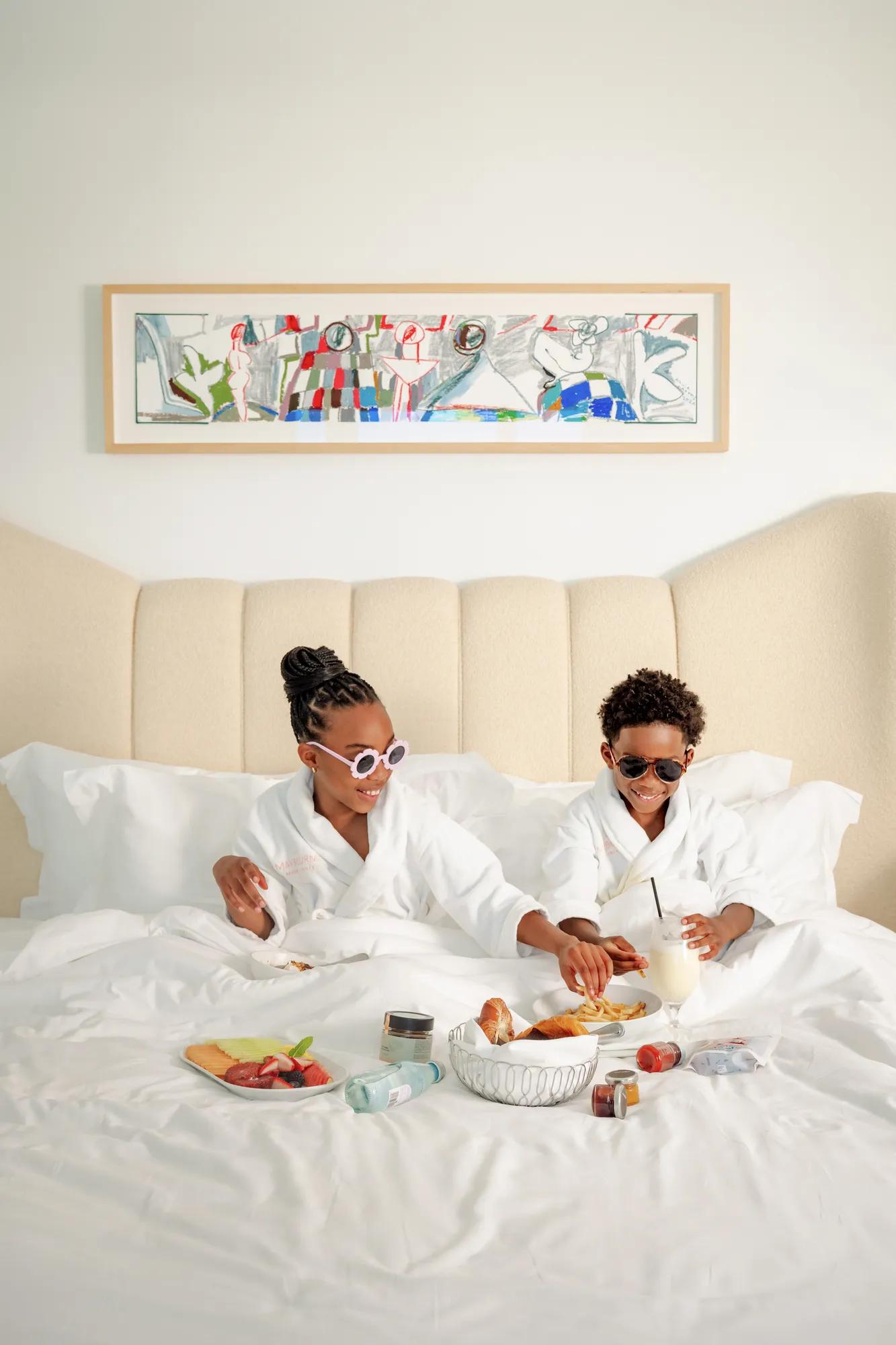 A boy and a girl enjoying in-room dining at a luxury hotel in Beverly Hills