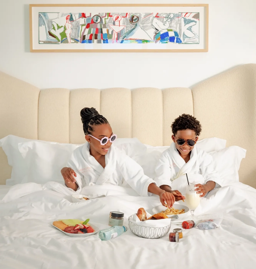 A boy and a girl enjoying in-room dining at a luxury hotel in Beverly Hills