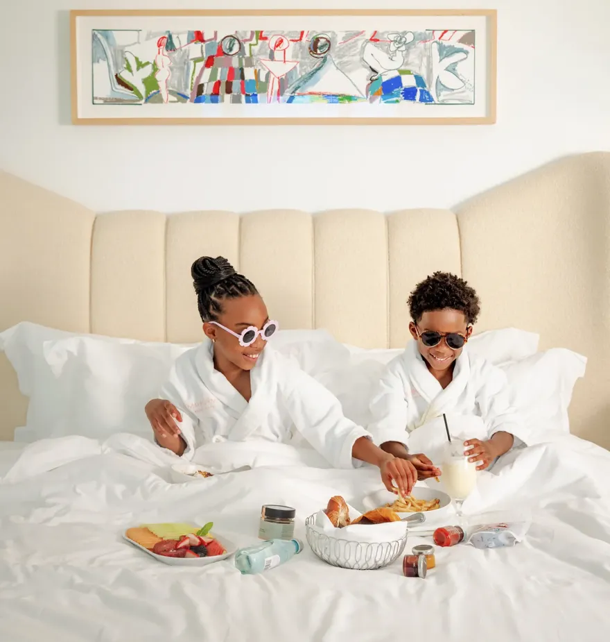A boy and a girl enjoying in-room dining at a luxury hotel in Beverly Hills