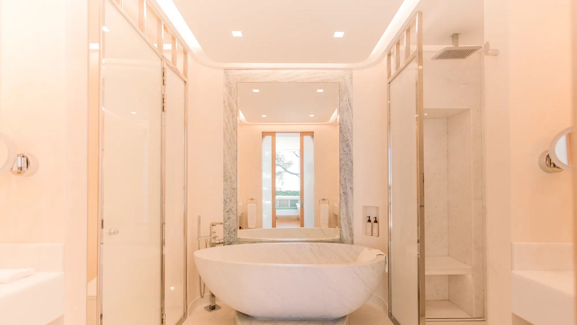 Elegant marble bathroom with freestanding bathtub, walk-in shower and double vanity.