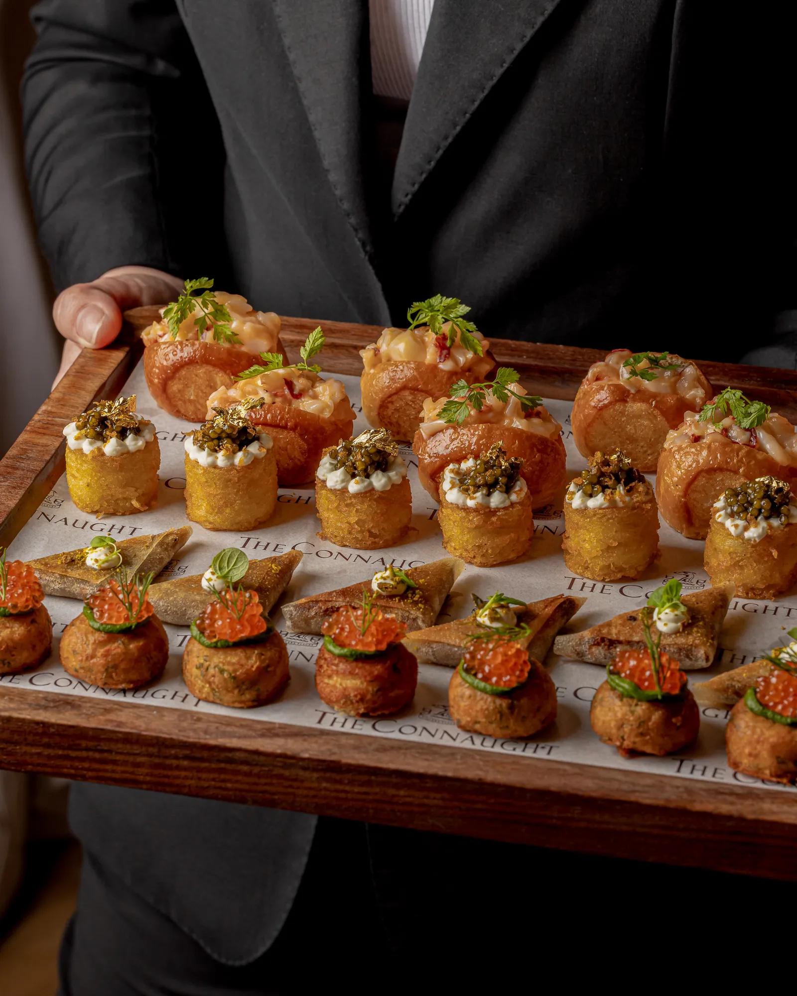 An elegant selection of canapés served for a private event at Claridge’s, presented with refined plating and arranged on a stylish display for a sophisticated reception.