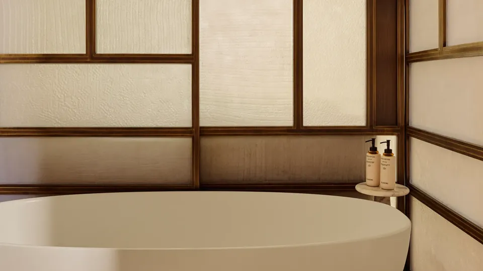 Freestanding oval bathtub set against a decorative wood-framed screen, with bath amenities on a small side table.