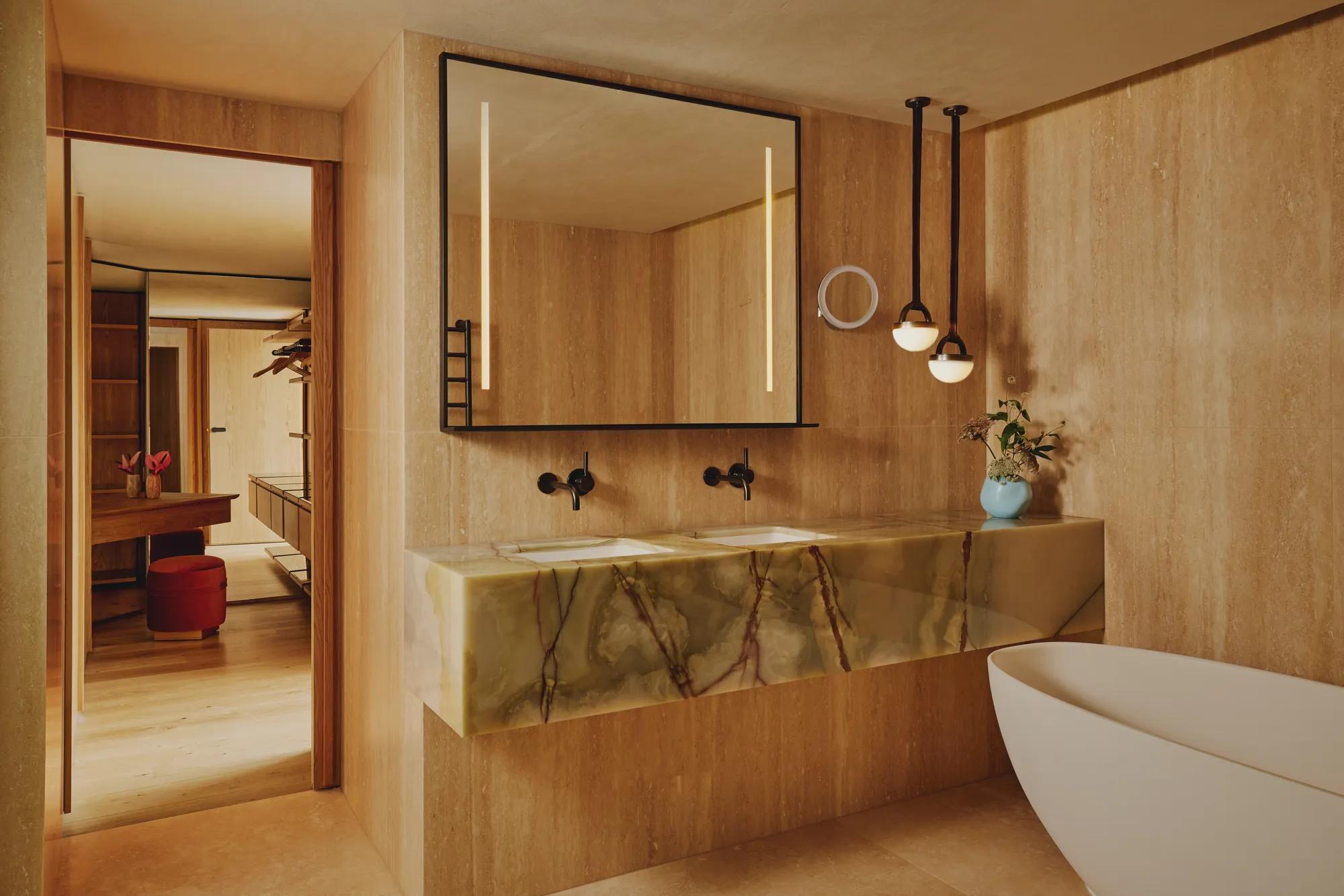 Marble bathroom with freestanding tub and double vanity.
