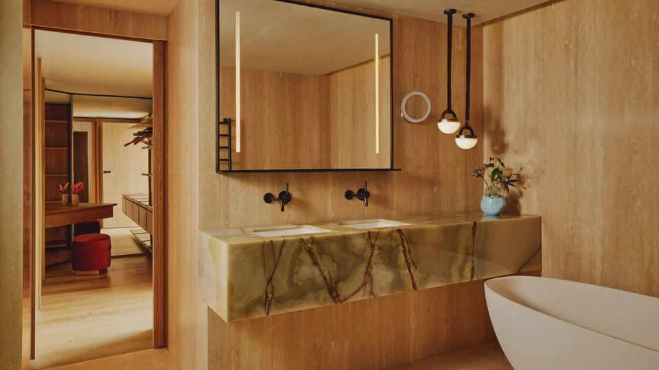 Marble bathroom with freestanding tub and double vanity.
