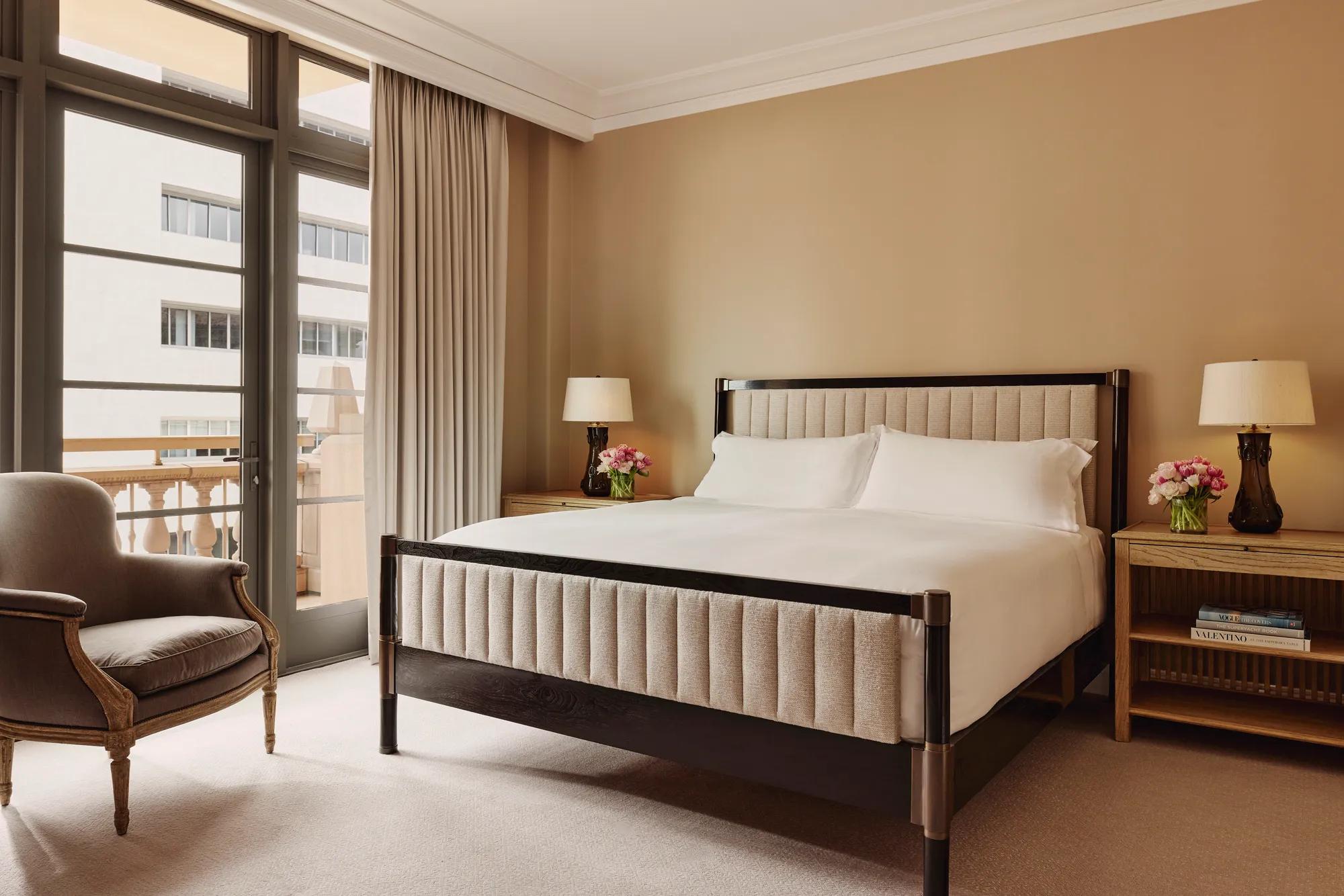 Bedroom in the Beverly Three-Bedroom Residence, designed with neutral tones, luxurious bedding, and full-height windows.