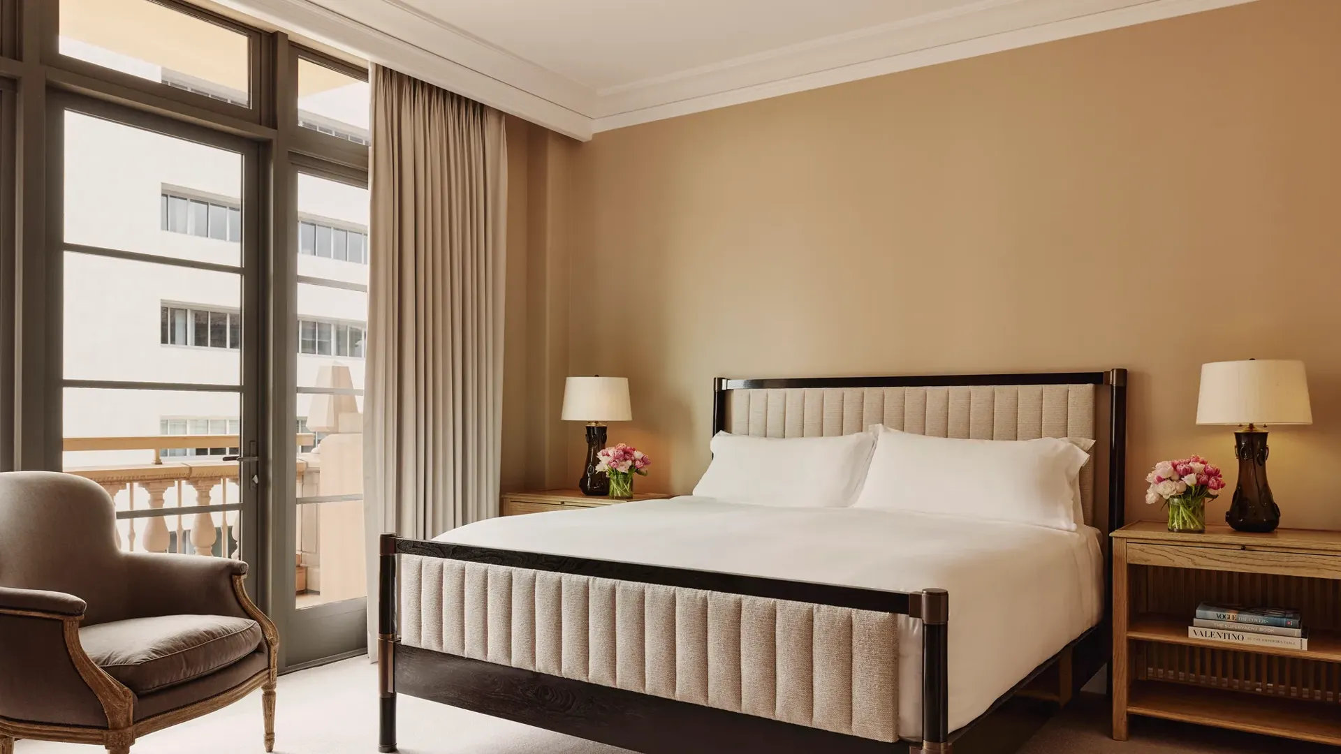 Bedroom in the Beverly Three-Bedroom Residence, designed with neutral tones, luxurious bedding, and full-height windows.