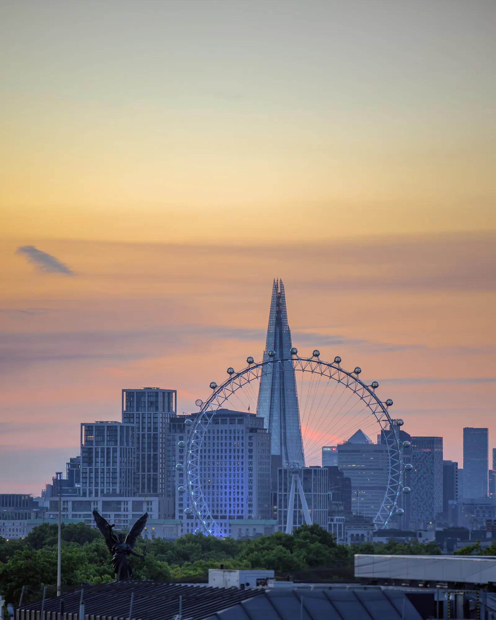London skyline at sunset, with the London Eye and The Shard