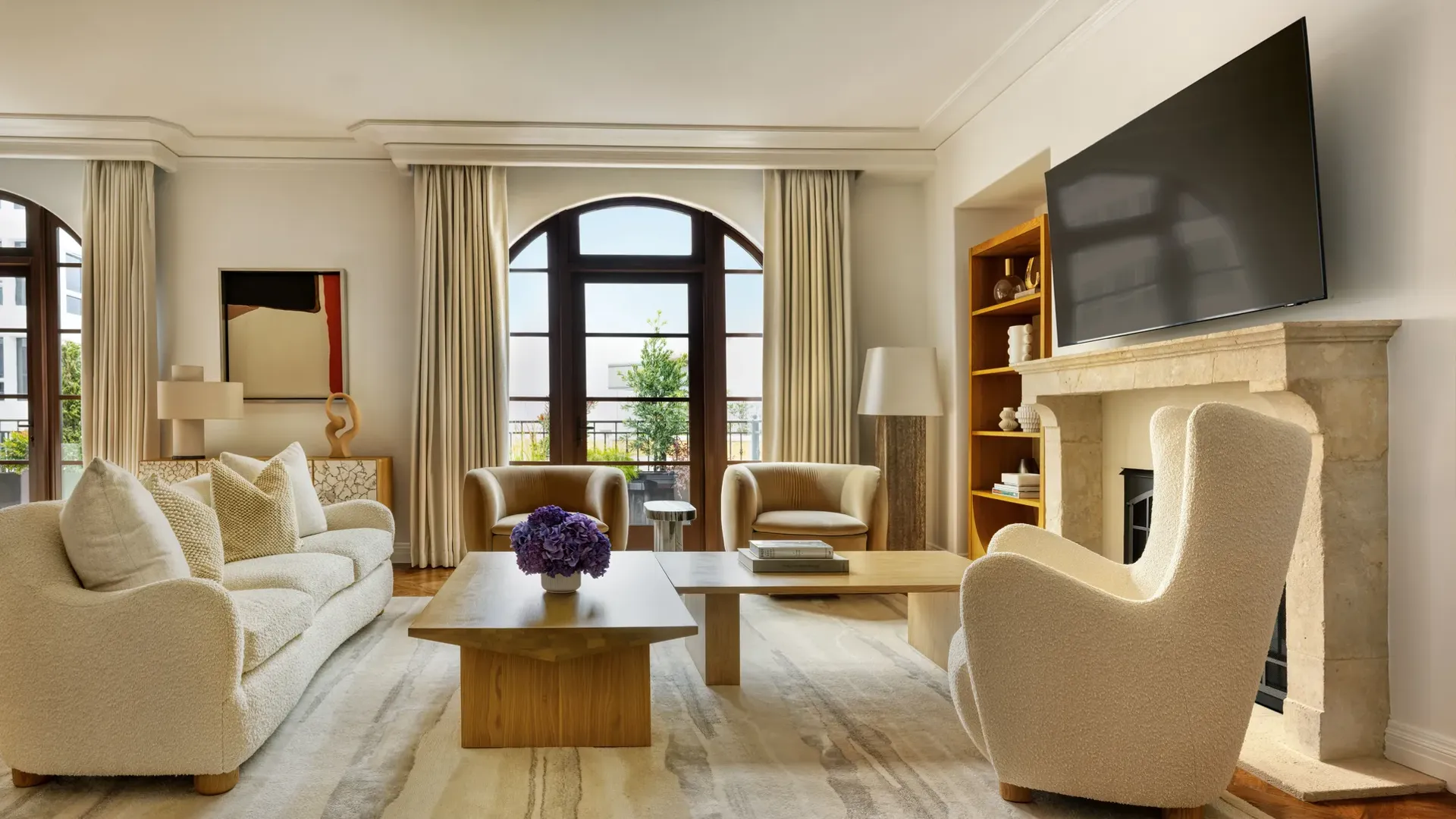 Dining space in The Maybourne Three-Bed Residence Wilshire with a large table, modern chairs, and floor-to-ceiling windows.