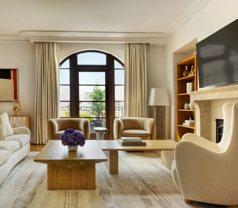 Dining space in The Maybourne Three-Bed Residence Wilshire with a large table, modern chairs, and floor-to-ceiling windows.