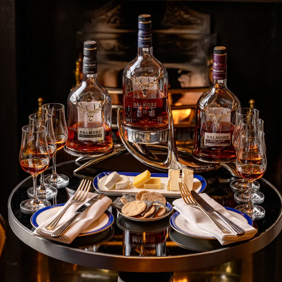 A couple of whisky bottles standing side by side, their labels and amber liquid clearly visible.