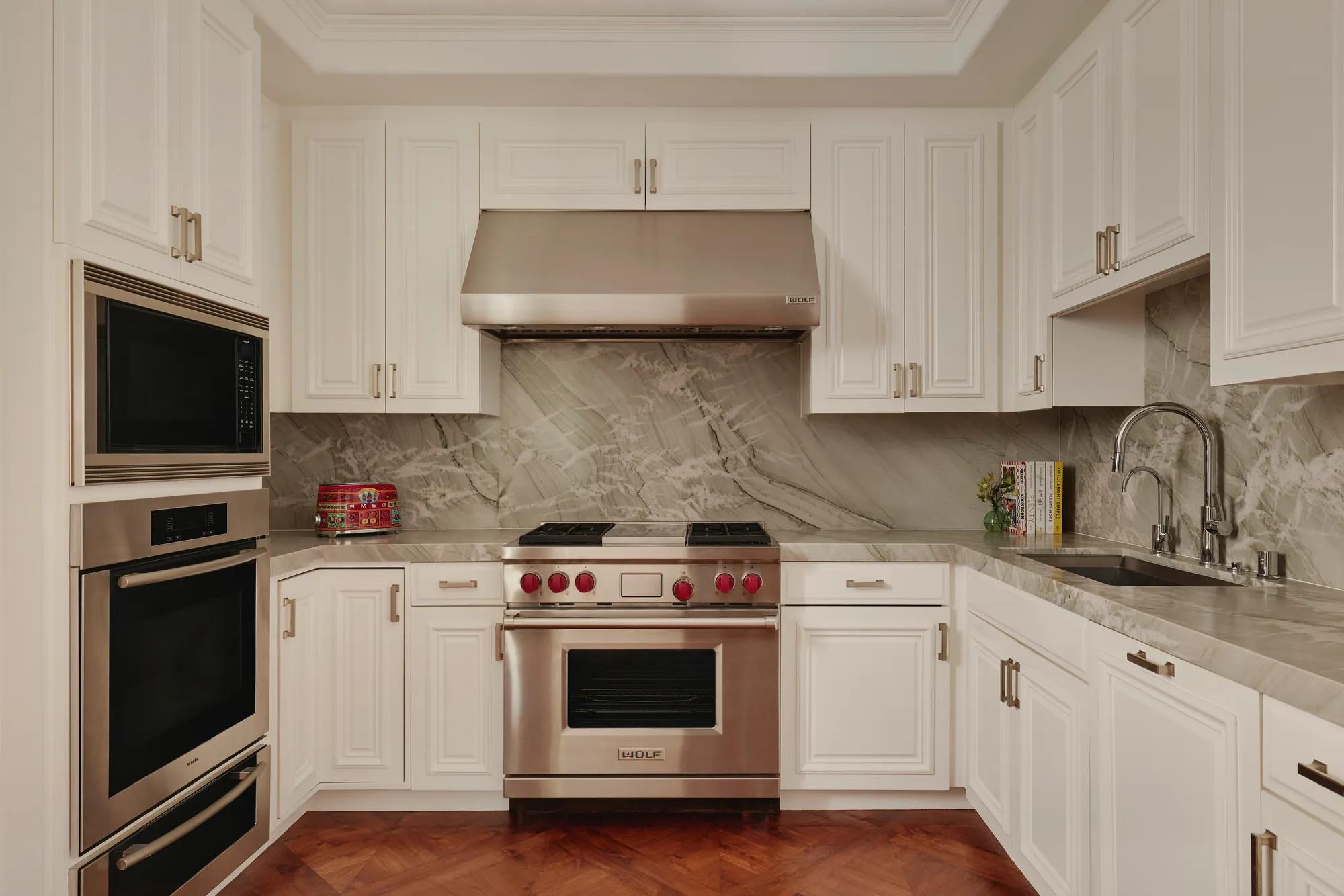 Modern kitchen in the Beverly Three-Bedroom Residence, with sleek cabinetry, premium appliances, and a breakfast bar.