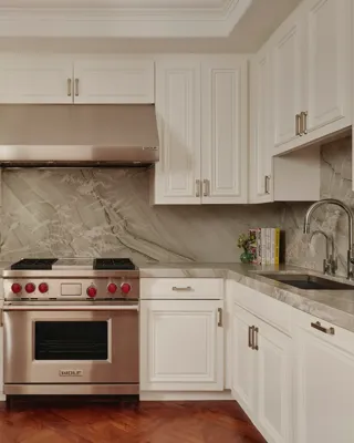 Modern kitchen in the Beverly Three-Bedroom Residence, with sleek cabinetry, premium appliances, and a breakfast bar.