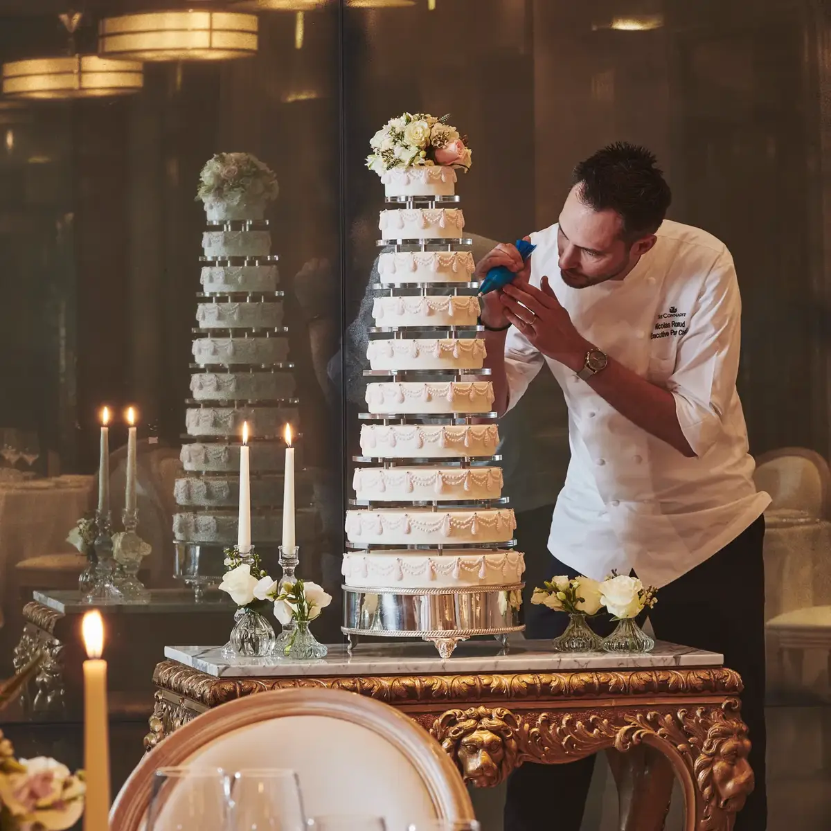 A selection of celebration cakes displayed in the Mayfair Room at Claridge’s, presented with elegant styling and refined decorative details for a special event