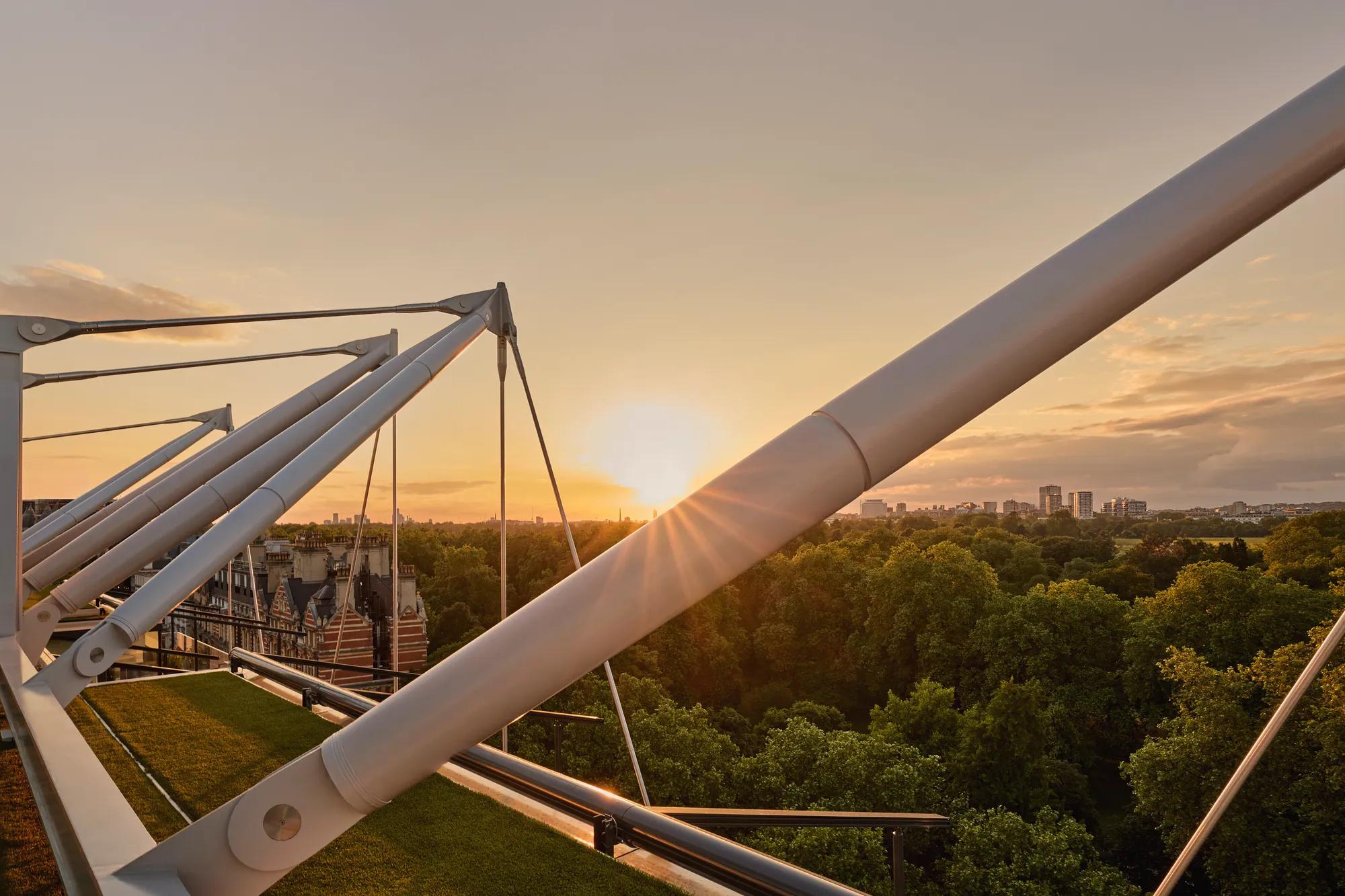 Sunset over Hyde Park viewed through The Emory’s architectural rooftop beams.