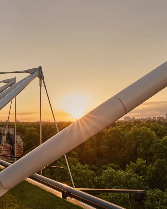 Sunset over Hyde Park viewed through The Emory’s architectural rooftop beams.