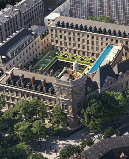 Aerial view of a historic city block with central courtyard garden, rooftop pool and surrounding stone buildings