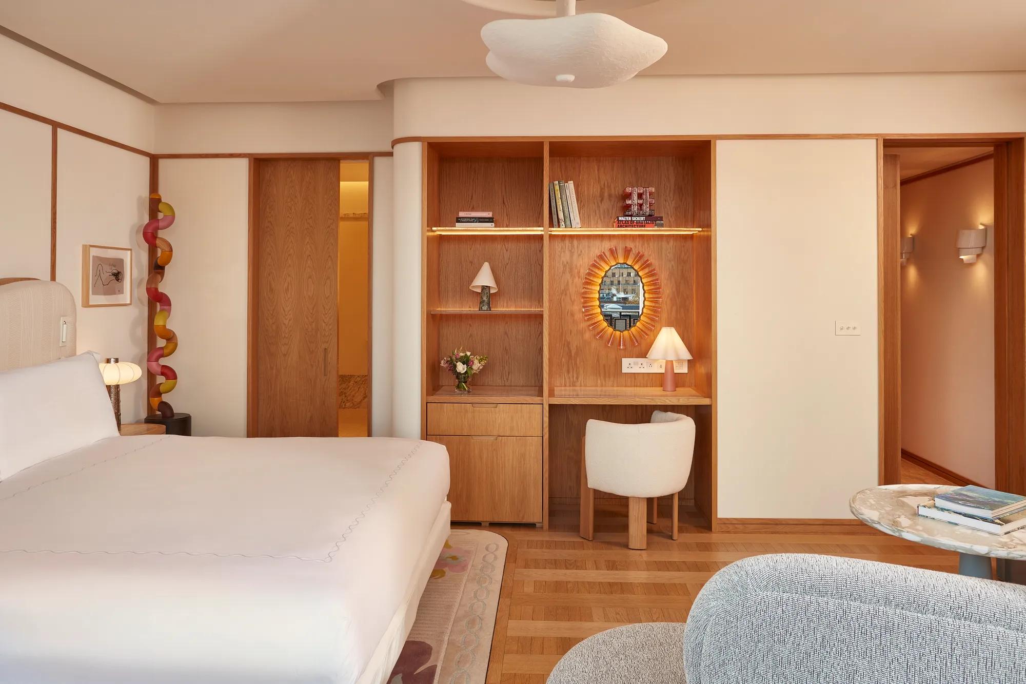 A Mayfair Balcony Room at Claridge’s featuring elegant contemporary décor, soft natural light, and access to a private balcony overlooking the surrounding neighbourhood.