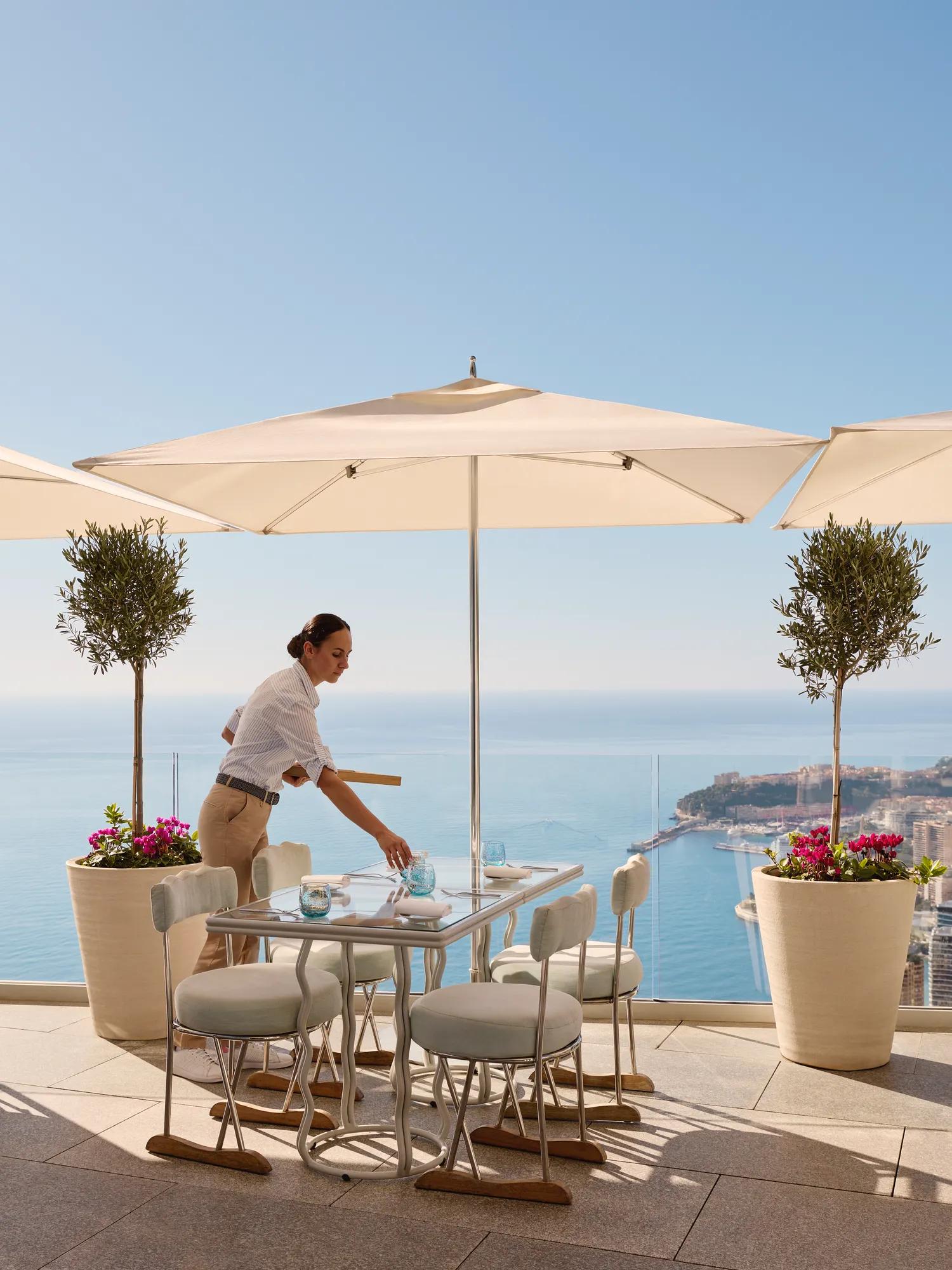 A member of the service team at the Riviera Restaurant at Maybourne Riviera, presenting refined hospitality in an elegant contemporary dining setting.