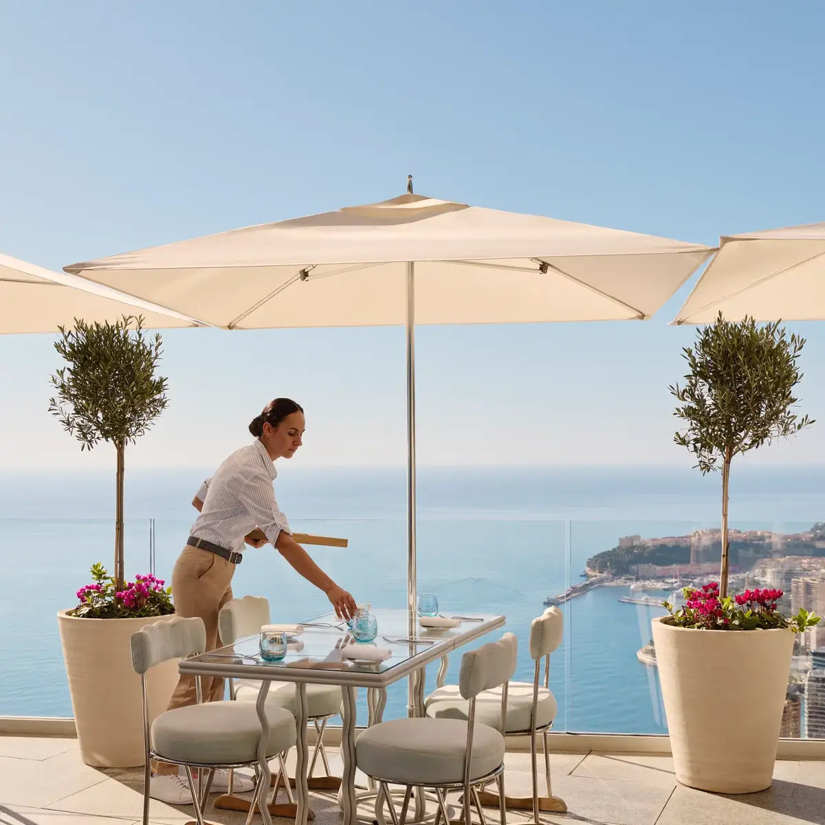 A member of the service team at the Riviera Restaurant at Maybourne Riviera, presenting refined hospitality in an elegant contemporary dining setting.