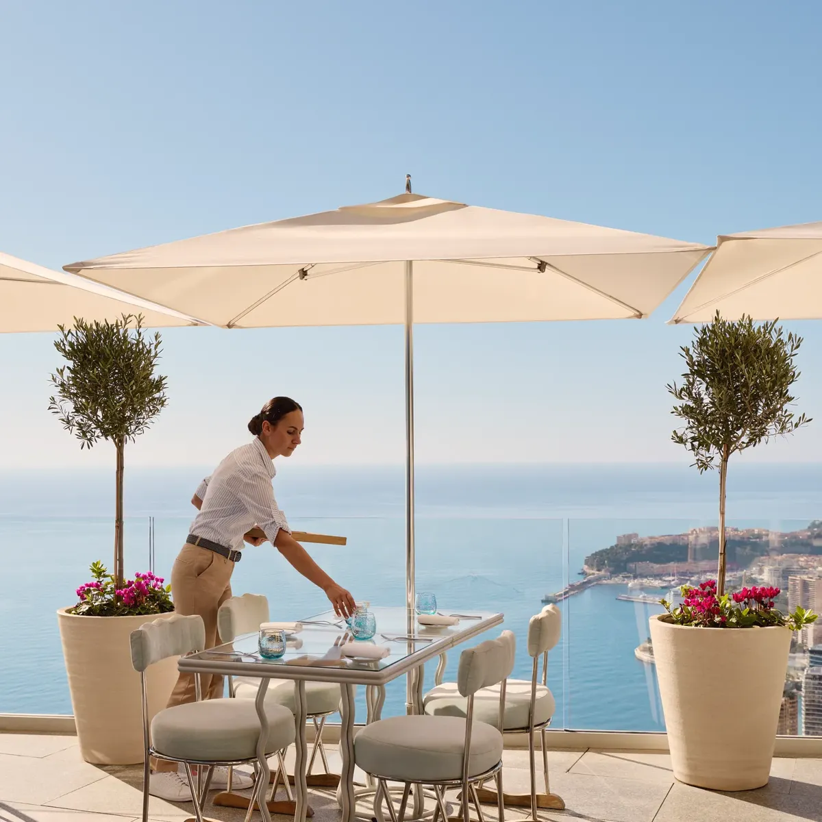 A member of the service team at the Riviera Restaurant at Maybourne Riviera, presenting refined hospitality in an elegant contemporary dining setting.