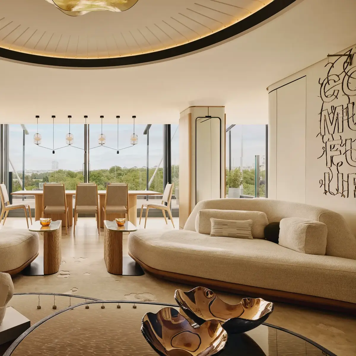 The Emory Penthouse lounge with curved sofas, sculptural accents, and panoramic Hyde Park views.