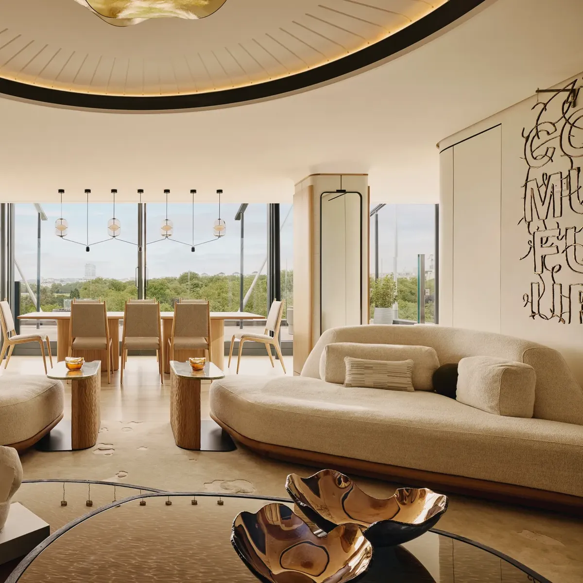 The Emory Penthouse lounge with curved sofas, sculptural accents, and panoramic Hyde Park views.