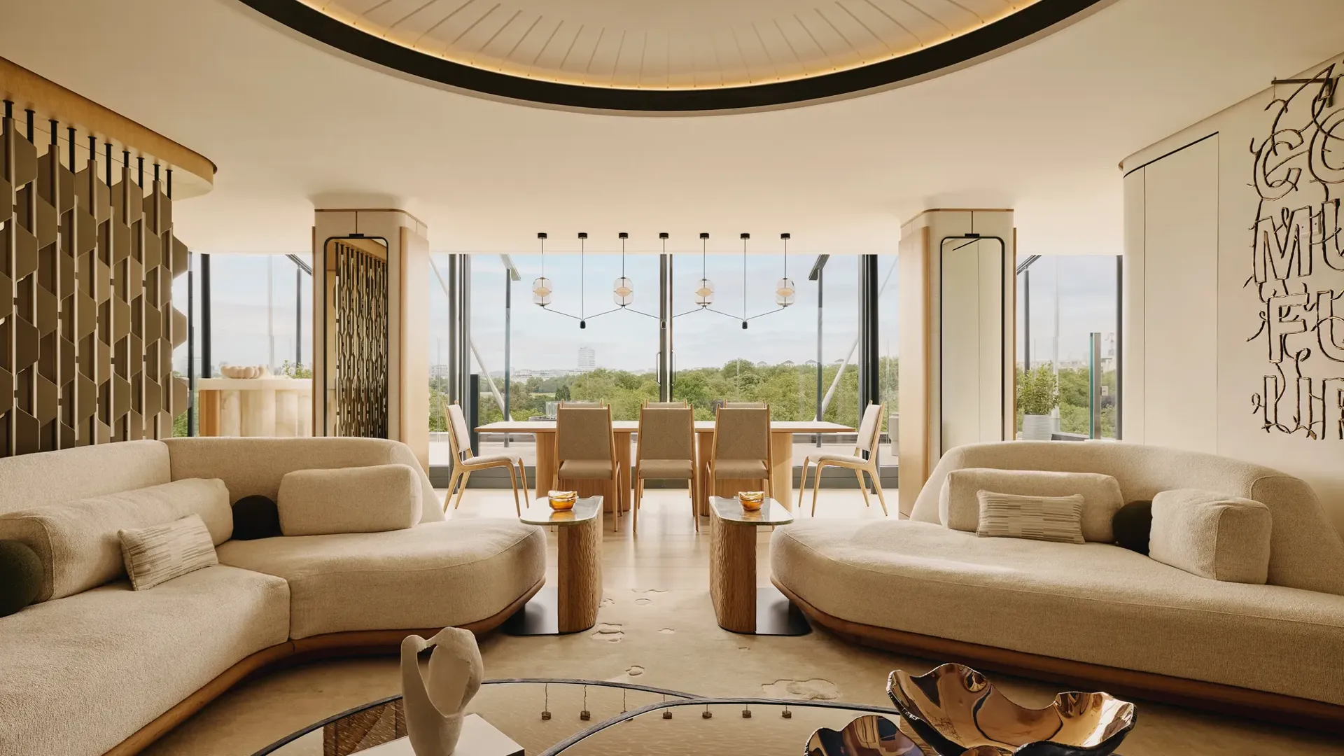 The Emory Penthouse lounge with curved sofas, sculptural accents, and panoramic Hyde Park views.