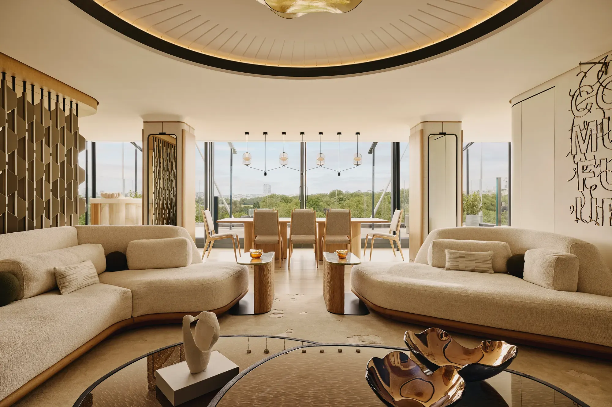 The Emory Penthouse lounge with curved sofas, sculptural accents, and panoramic Hyde Park views.