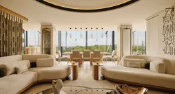 The Emory Penthouse lounge with curved sofas, sculptural accents, and panoramic Hyde Park views.